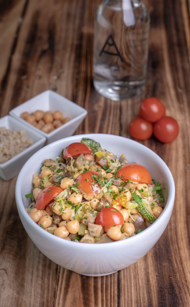 Chickpea Salad in a white ball on a wooden table