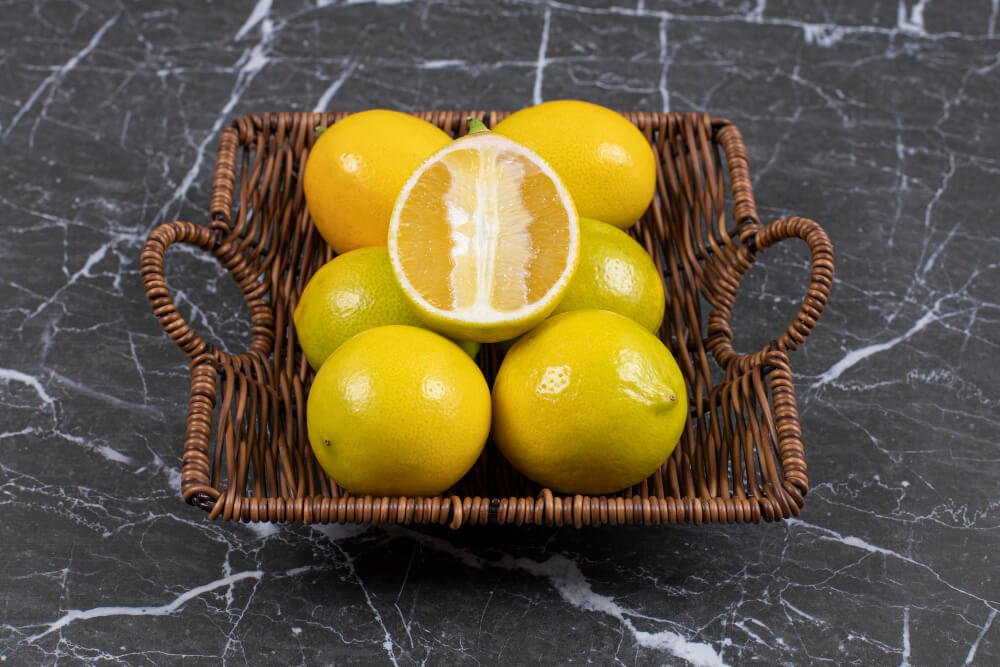 Some fresh lemons in a wooden jar