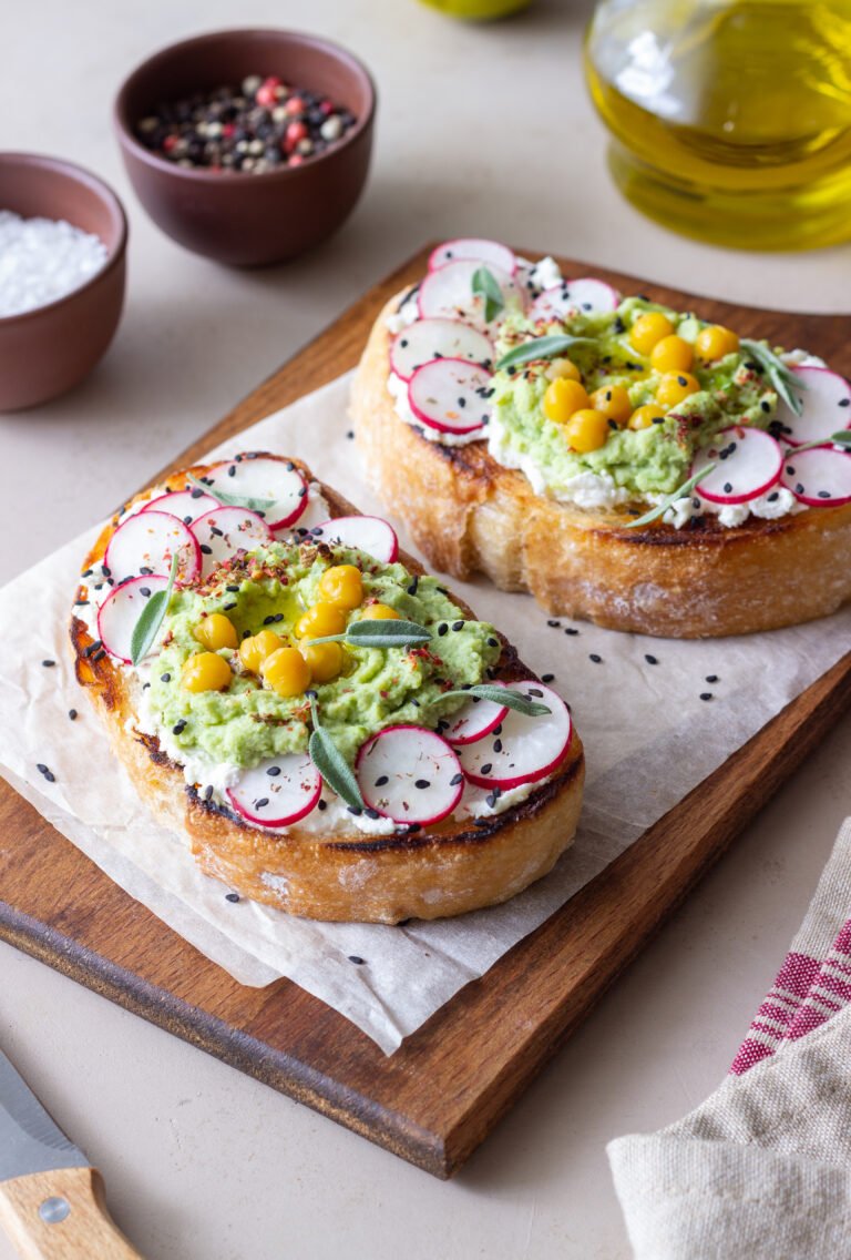 Bruschetta with guacamole, radish, white cheese, chickpeas and sage. Vegetarian food. Sandwich. Italian food