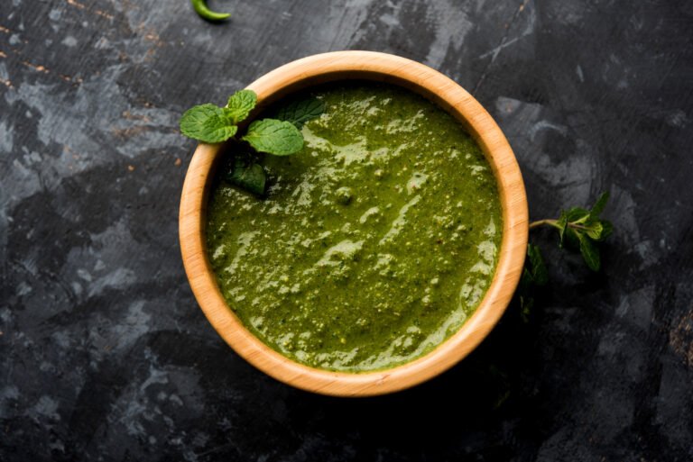 Healthy Green Mint Chutney Made with Coriander, pudina And Spices. isolated moody background