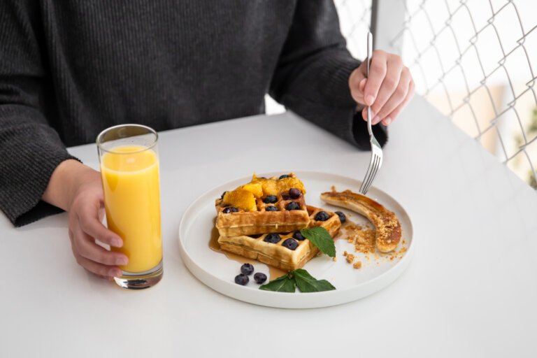 A man having his breakfast and a glass of juice