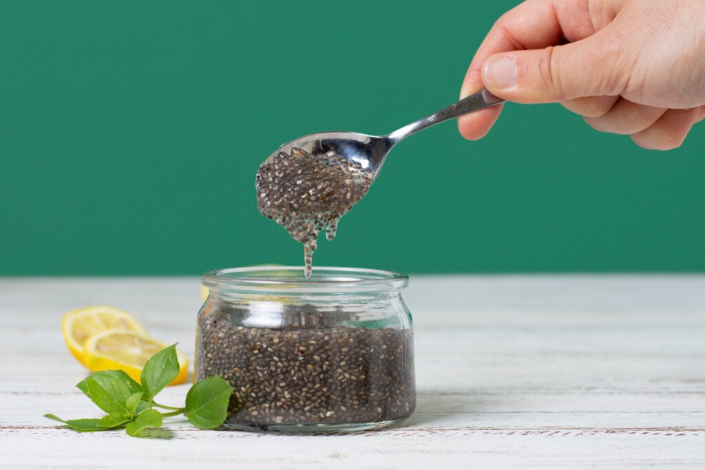 chia seeds in a small glass jar on a wooden white table