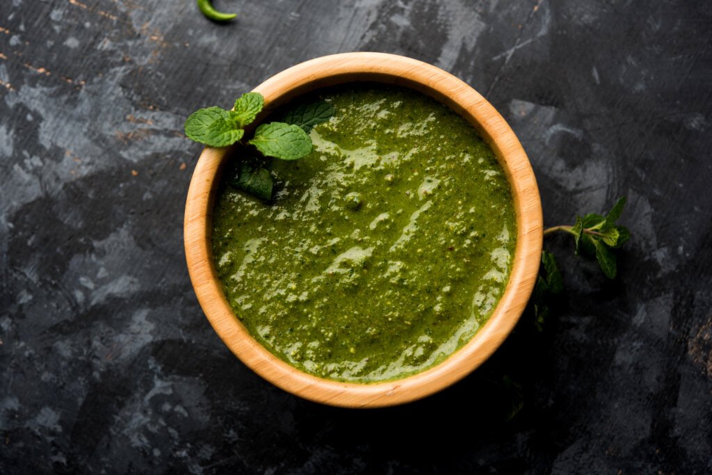 Healthy Green Mint Chutney Made with Coriander, pudina And Spices. isolated moody background. selective focus