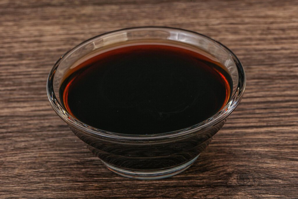 Teriyaki sauce on a small transparent glass bowl